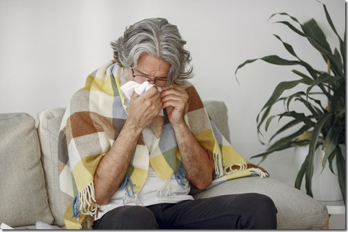 Old and sick senior man sitting at home